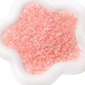 Perles de rocaille œil de chat rose aurore pour bijoux DIY dans un plat à fleurs - Rose rose