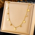 Close-up of gold stainless steel necklace with small flowers and cubic zirconia pendants - Five-Petal Flower Style (N3056)