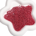 Perles de rocaille rouges dans un plat en étoile blanche pour création de bijoux - Rouge