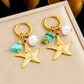 Gold starfish hoop earrings with white pearls and turquoise stones on a display box - E6243