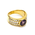Detailed macro view of vintage gold ring with large purple zircon and side crystal accents - US 6 / Gold Purple Gemstone