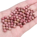 Hand-held close-up of pink natural stone round beads for DIY jewelry making - Diameter 6mm Hole Approx 1mm 10 Pcs/Pack / Natural Rhodonite