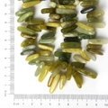 Natural long stone beads in olive green and yellow tones shown on a metric scale - 10-30mm 38cm/str Approx 50pcs / Natural Serpentine Jade