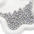 Mix of metallic silver ABS imitation pearls in a ceramic tray for DIY jewelry making - 3-8mm / Light Silver Grey