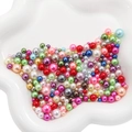 Mix of colorful ABS faux pearls in a white ceramic dish for DIY handmade jewelry - 3-8mm / Multi-color
