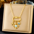 Detailed view of a gold plated necklace featuring star and evil eye charms on a paperclip chain - Evil Eye and Pave Pentagram Style (N3433)