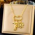 Detailed close-up of gold seahorse, anchor, and whale tail pendants on a paperclip chain - Seahorse Helm and Whale Tail Style (N3432)