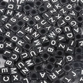Macro detail of black square acrylic alphabet beads with white letters for DIY jewelry - Square Black with White Letters / 100 Pieces/Pack (6x6mm)