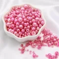 Peach Pink ABS faux pearl beads for DIY jewelry making in a white ceramic bowl - Hot Pink