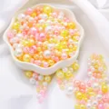 Mix of white, yellow, and pink ABS faux pearls in a floral bowl for DIY jewelry making - Snowy Sakura Mix
