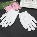 Pair of white cotton gloves for jewelry handling and precision work on a black mat - One Size / 1 Pair / White