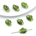 Detailed macro view of hand-painted fish-shaped ceramic beads for DIY jewelry making - Plaid Fish Style / 2 Pieces/Pack / Grass Green