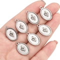 Set of seven silver alloy tulip relief oval charms for DIY necklace making - Oval Tulip