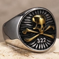 Macro detail of retro punk skull ring with golden 322 crossbones on aged titanium steel - US 7 / Gold & Silver