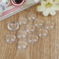 Set of 10 clear round glass cabochons for DIY jewelry making on a wooden background - 16mm - 30 Pieces/Pack