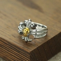 Macro shot of gothic cross ring featuring a 3D gold skull and embossed floral details - Number 7 / Gold & Silver