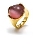 Close-up of golden stainless steel ring with a large pink cat eye stone on white background - Gold Pink Cat Eye Stone