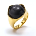 Macro shot of gold plated titanium steel ring with a large black cat eye stone inlay - Gold Black Cat Eye Stone
