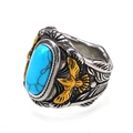 Detailed view of the titanium ring featuring a blue turquoise stone and golden eagle motif - US 7 / Two-Tone Gold