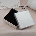 Close-up of a square silver jewelry gift box with metallic mesh texture and black velvet lining - Black Gift Box