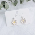 Close-up of daisy earrings with 925 silver posts and white pearls on jewelry card - White Daisy Pattern