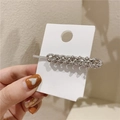 Close-up of silver chain hair clip with sparkling rhinestones on a display card - Silver