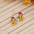 Detail of yellow enamel daisy earring with small diamonds and a white pearl accent - Yellow