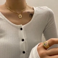 Golden tulip necklace and ring set with floral relief on elegant woman wearing cardigan - Tulip Necklace