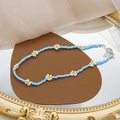 Detail of beaded daisy necklace with light blue seed beads and floral patterns - Blue Beaded Daisy Choker
