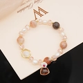 Detail of beaded bracelet featuring freshwater pearls, pink crystals and floral charms - Natural Raw Rose Quartz Bracelet