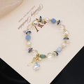 Detail of beaded bracelet with blue crystals, pearls and iridescent teardrop pendant - Aquamarine Natural Pearl Bracelet