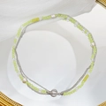 Multi-layer necklace with green beads, pearls and silver chains featuring a stylish OT clasp - As Shown