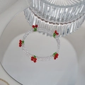 Detail of beaded bracelet with red cherry accents on clear triple-strand crystal beads - Transparent Crystal Cherry Bracelet