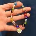 Close-up of a colorful beaded glass bracelet featuring a white daisy flower charm detail - Lampwork Bracelet Daisy Pendant (Elastic)