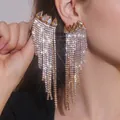 Close-up of long gold fringe earrings with amber teardrop stones and sparkling crystals - Full Diamond Long Tassel Style (JXER150) / Gold