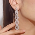 Elegant silver sparkling rhinestone teardrop drop earrings worn by a model for gala events - Silver Four-Link Pear-Shaped Segmented Long Earrings DTE1617095S-W