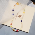 Detail of beaded necklace with freshwater pearls, colorful mushrooms and floral charms - Red Mushroom Lampwork Necklace