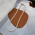 Detailed macro view of 4mm glass pearl necklace with gold lobster clasp and extension chain - 4mm Style