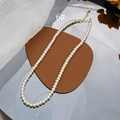 Close-up of creamy white pearl necklace with adjustable gold lobster clasp and chain - 6mm Style