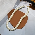 Detail of elegant cream glass pearl necklace with gold clasp on a mirror tray - 12mm Style