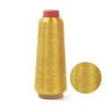 Metallic gold embroidery thread spool with macro detail showing shimmering texture - Gold