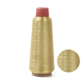 Metallic gold embroidery thread spool with circular detail of its woven texture - KC Gold