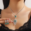 Detailed close-up of emerald green crystal necklace and earrings set on model's neck - Green 208-Square Snowflake