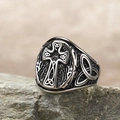 Macro detail of vintage Celtic cross ring with intricate knotwork on textured stone - US 6 / Steel