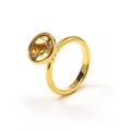 Detail view of oval yellow gemstone bezel set in minimalist 18k gold plated titanium ring - Gold Champagne Stone
