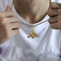 Close-up of golden muscular bull pendant on box chain worn over a white t-shirt - Gold Color Pendant (No Chain)