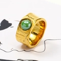 Macro detail of gold textured irregular ring featuring a green ceramic stone inlay - US 6 / Gold Green