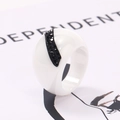 Macro shot of wide white ceramic ring with a black micro-pave diamond crescent inlay - US 6 / White With Black Rhinestone