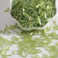 Iridescent light green glass bugle beads in a ceramic bowl for DIY jewelry making - 15g/Pack (Approx. 300 Pcs) / Olive Green