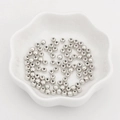 Bulk silver plastic CCB round spacer beads in a white ceramic dish for jewelry making - Diameter 4mm (300 Pcs/Pack) / White K Plated